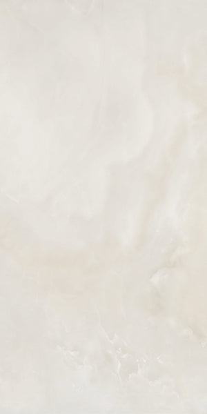 A smooth, light beige marble surface with subtle veining and soft, cloudy patterns throughout. The texture appears polished and glossy, giving a clean and elegant appearance.