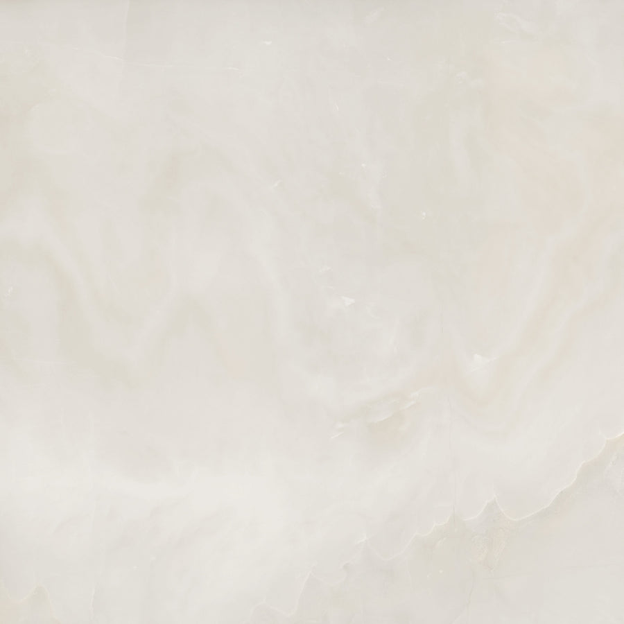 A smooth, light beige marble surface with subtle white and cream swirls and soft, cloudy patterns throughout.