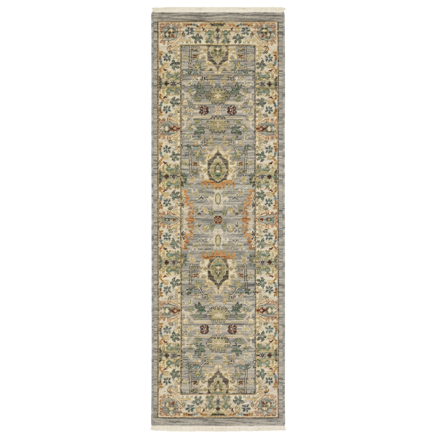A rectangular runner rug with a muted color palette featuring intricate floral and geometric patterns in shades of gray, green, gold, and blue, with a decorative border.