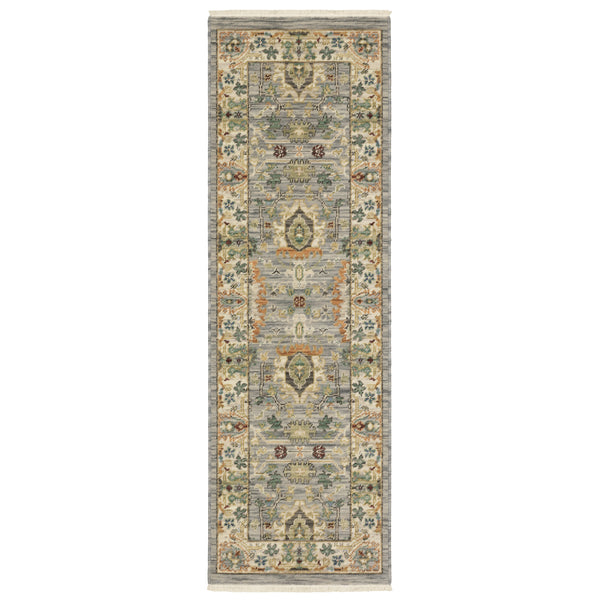 A rectangular runner rug with a muted color palette featuring intricate floral and geometric patterns in shades of gray, green, gold, and blue, with a decorative border.