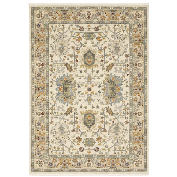 The Lucca 2063Y Area Rug showcases intricate floral and geometric patterns in light beige, gold, blue, green, and brown with a detailed border—an elegant choice for contemporary spaces.