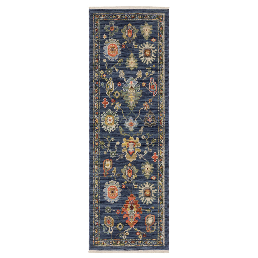 A rectangular blue runner rug with a traditional design featuring colorful floral and geometric patterns in shades of red, gold, cream, and green. The rug has a decorative border and intricate detailing.