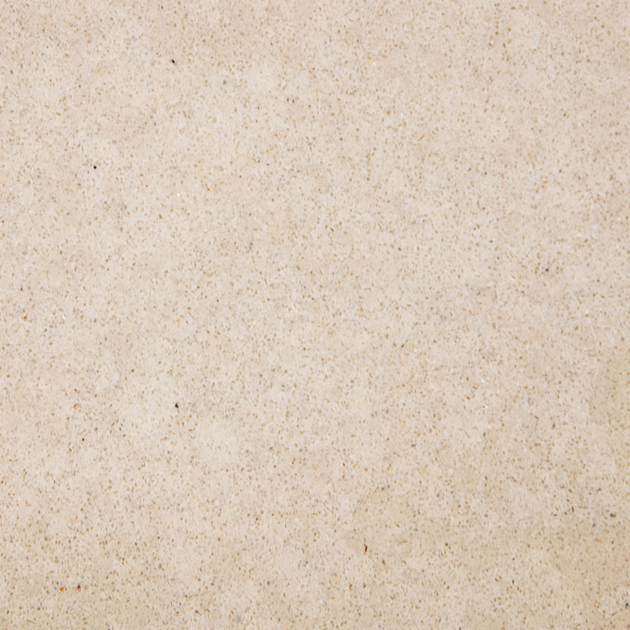 Close-up of a light beige sandy-textured surface with small dark brown specks, perfect for pairing with the Quad Shower Shelf to enhance a modern bathroom shelf setup.