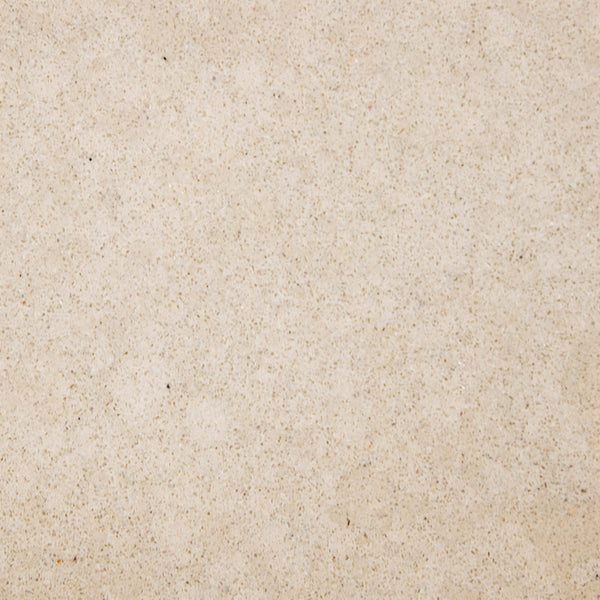 A close-up of a smooth, beige sandy surface with fine texture and subtle specks, reflecting the elegant finish featured on the Quad Shower Shelf.