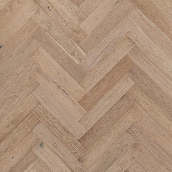 Main Street Herringbone White Oak Hardwood features light brown luxury planks with a herringbone pattern, showcasing the natural wood grain and subtle knots of elegant white oak.