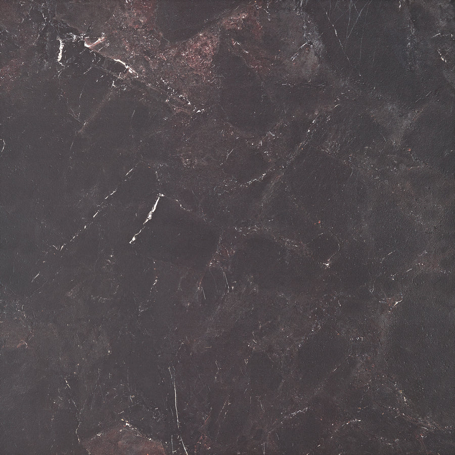 A close-up of Cavallo Dusk Rectified 48" x 48" Tile in Natural; its dark, textured stone look has black, brown, and subtle reddish hues with thin white and gray veining—perfect for modern spaces or premium oversized flooring.