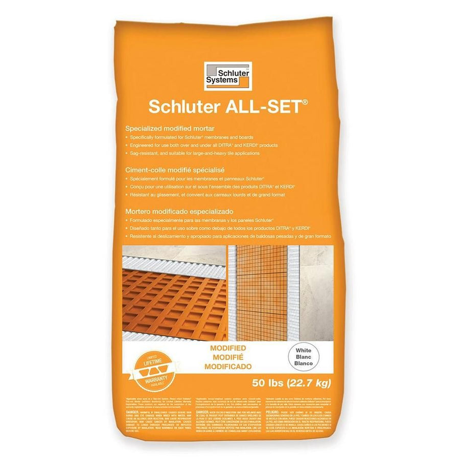 A 50 lb orange bag of Schluter All-Set thin-set mortar features product details in English, French, and Spanish, images of tiling over Schluter membranes, and the label "White" in the bottom right corner.