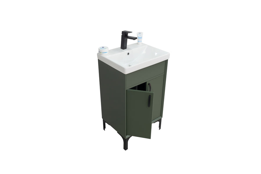 A small green bathroom vanity with a white sink, black faucet, and two cups on the counter; one cabinet door is partially open, revealing the interior. The background is plain white.