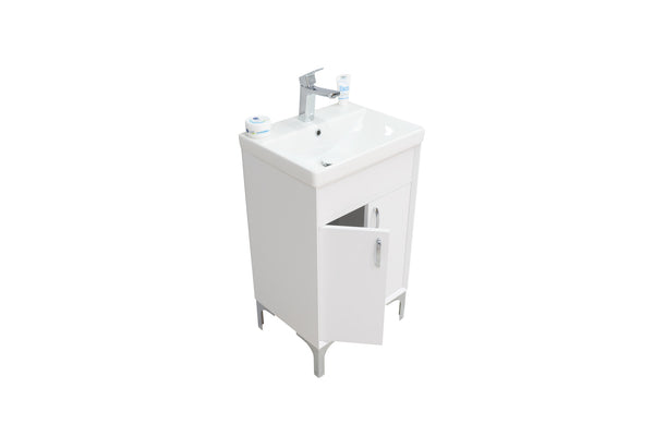 A white bathroom sink cabinet with a single faucet, two small containers on the countertop, and one cabinet door partially open, isolated on a white background.