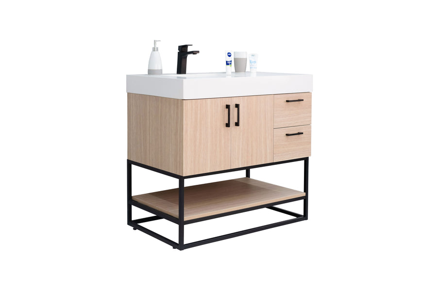 A modern bathroom vanity with a white sink, black faucet, light wood cabinets, two drawers, a lower shelf, and black metal frame. Toiletries are placed on top of the sink. The background is white.