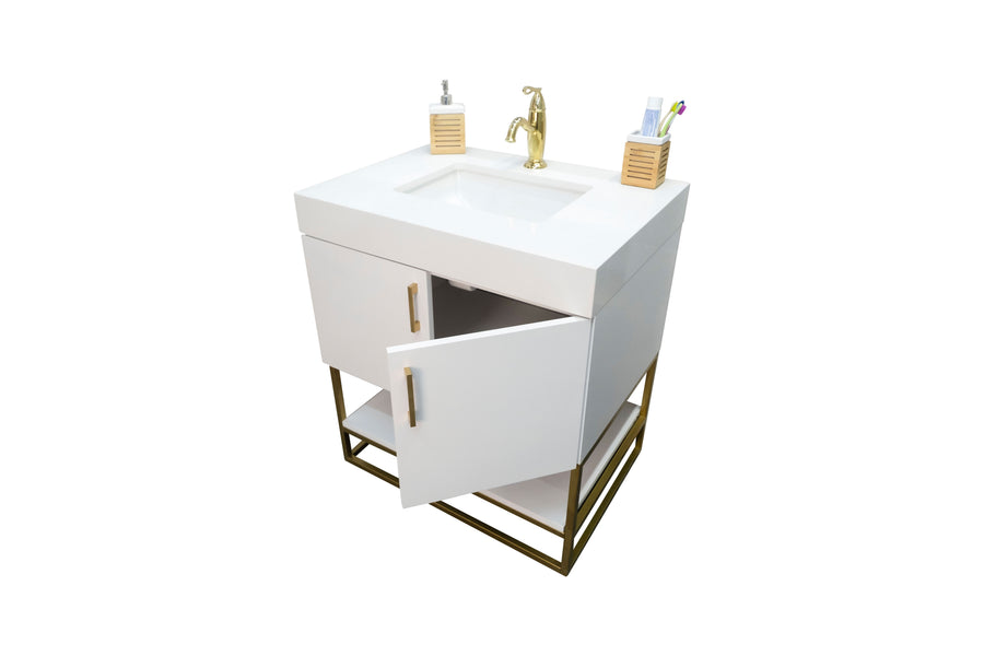 A modern white bathroom vanity with a gold faucet, an open cabinet door, and two soap dispensers and a toothbrush holder on top, standing on a gold metal frame.