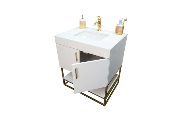 A modern white bathroom vanity with a gold faucet, an open cabinet door, and two soap dispensers and a toothbrush holder on top, standing on a gold metal frame.