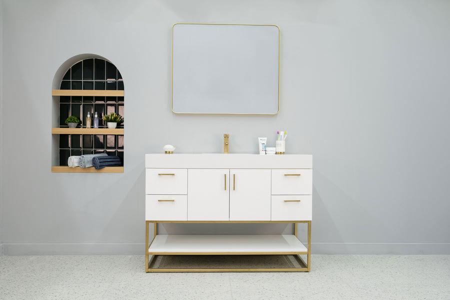 A bathroom with a mirror and sink featuring the Solana 48" Vanity for a sleek, updated look.