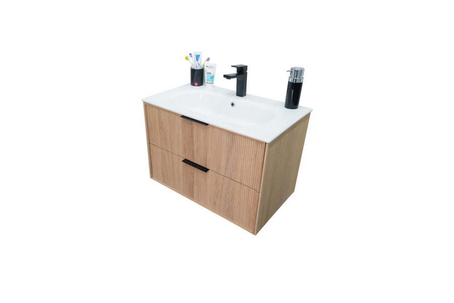 A modern bathroom vanity with a white sink, black faucet, two wood-textured drawers, and toiletries including toothbrushes, toothpaste, and soap dispensers on the countertop.