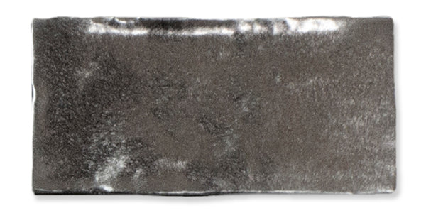 A rectangular, shiny, grey faux fur fabric piece with a soft, plush texture laid flat against a white background.