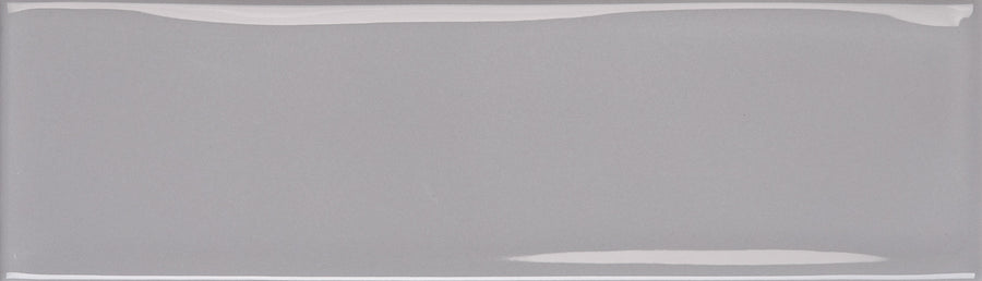 The Maestro 3" x 10" Subway Tile in Wolfgang Glossy features a smooth, reflective gray finish and rounded edges—ideal for modern bathroom walls or a stylish kitchen backsplash.