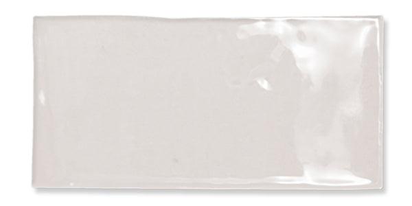 A rectangular, glossy, off-white ceramic tile with slightly uneven edges and a smooth, shiny surface.