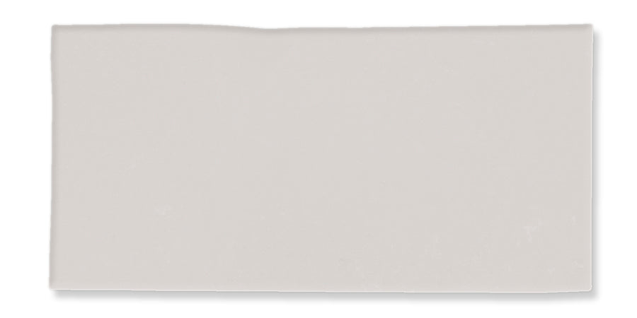 A rectangular, light gray tile with a slightly uneven top edge and a smooth surface, shown against a white background.