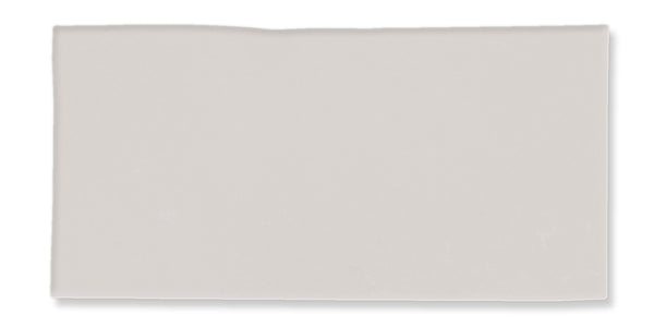 A rectangular, light gray tile with a slightly uneven top edge and a smooth surface, shown against a white background.