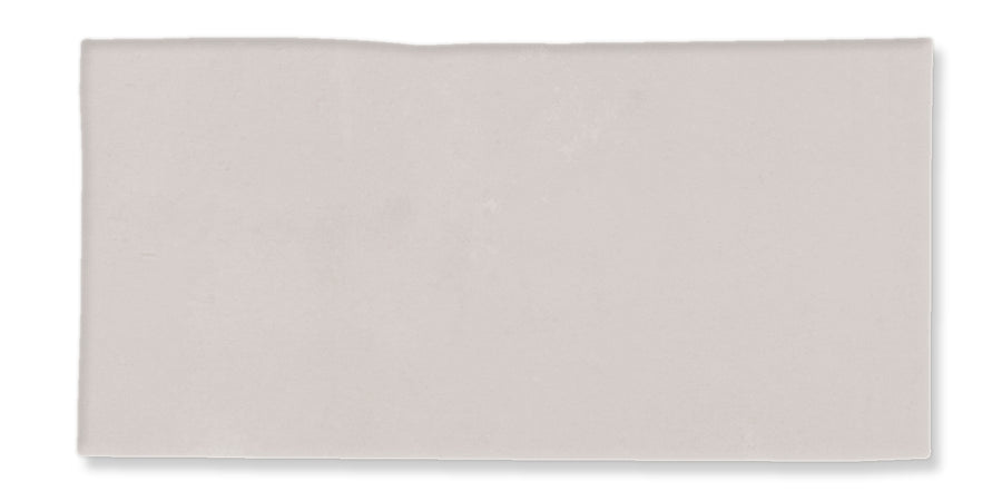 A plain, light gray rectangular tile with a slightly uneven upper edge, set against a white background.