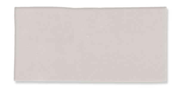 A plain, light gray rectangular tile with a slightly uneven upper edge, set against a white background.