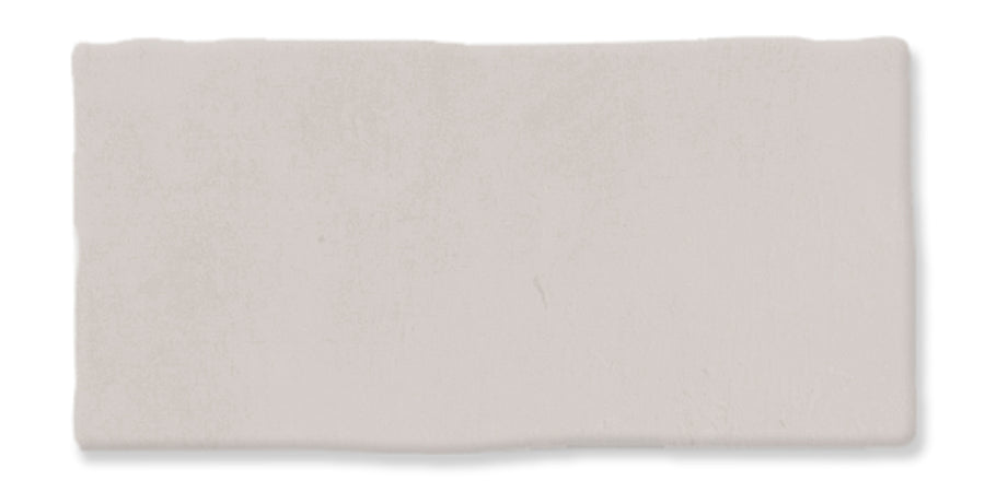 A rectangular, off-white ceramic tile with slightly uneven edges and a matte finish.