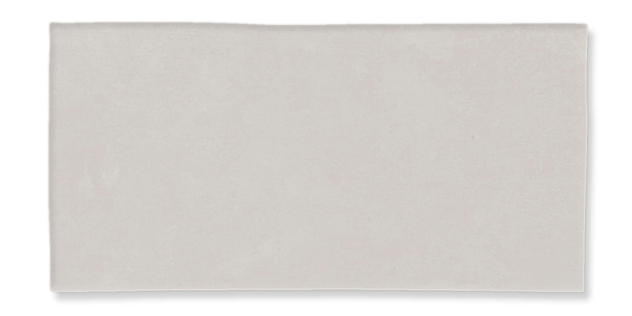 A rectangular, light grey ceramic tile with a smooth, matte finish and subtle texture.