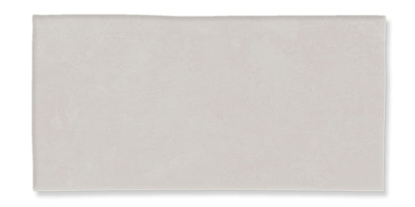 A rectangular, light grey ceramic tile with a smooth, matte finish and subtle texture.