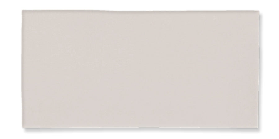 A plain, rectangular, off-white or light gray tile with a smooth surface and slightly irregular edges, displayed against a white background.