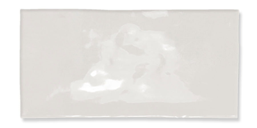 A rectangular, glossy white tile with a slightly uneven surface and subtle reflections, set against a plain white background.