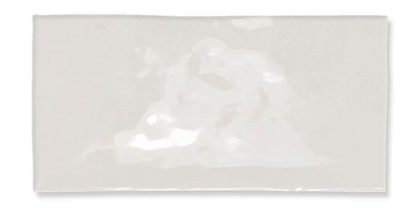 A rectangular, glossy white tile with a slightly uneven surface and subtle reflections, set against a plain white background.