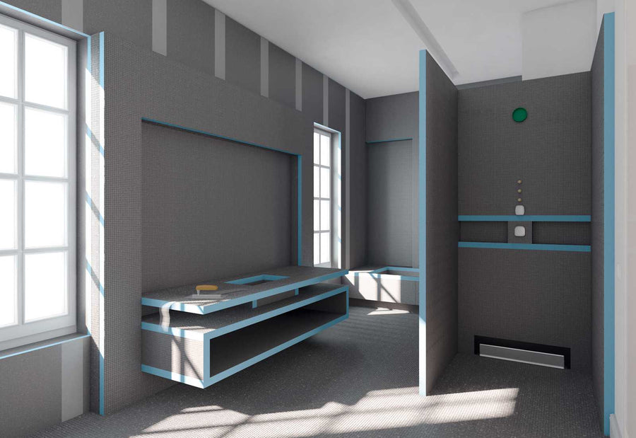 A minimalist, modern prison cell with gray walls and blue trim uses durable, waterproof Wedi Boards. It includes a built-in bed, desk, shelf, separate toilet area, and large windows for natural light.