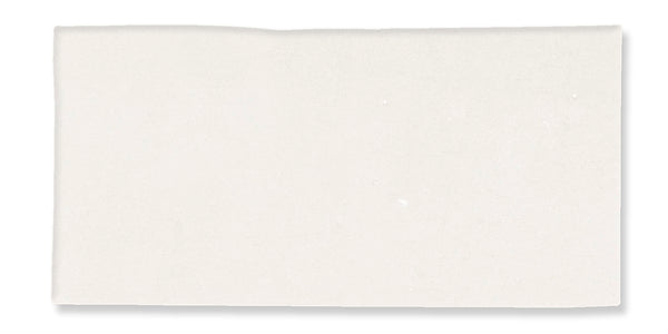 A plain, rectangular white sheet of paper with a slightly uneven top edge, set against a white background.