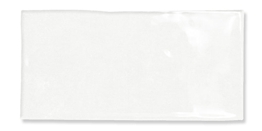 A glossy white rectangular subway tile with a slightly uneven surface and smooth edges, photographed against a white background.
