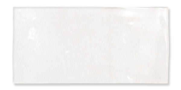 A rectangular, glossy white tile with slightly uneven surface texture and subtle variations in shading, photographed against a white background.