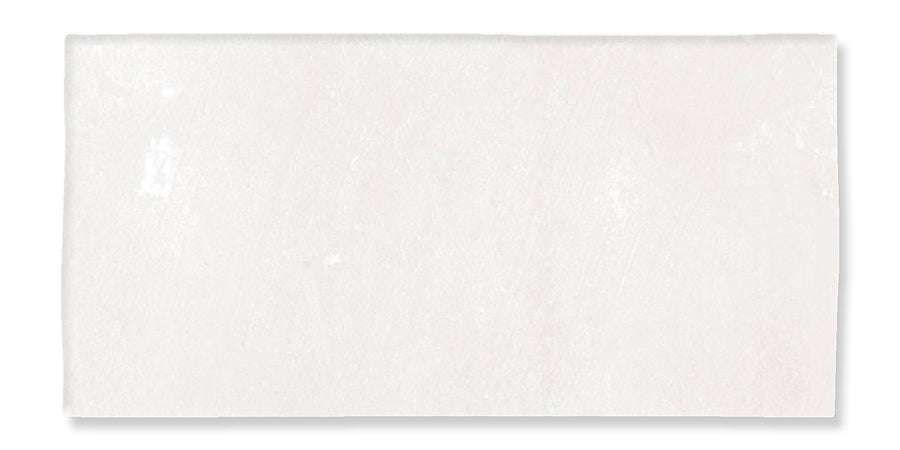 A rectangular, off-white ceramic tile with a slightly uneven surface and subtle texture, set against a white background.