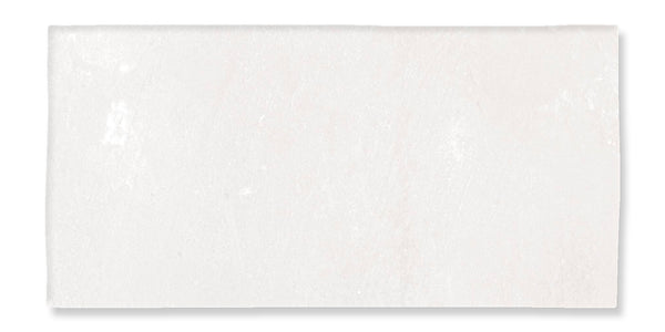 A rectangular, off-white ceramic tile with a slightly uneven surface and subtle texture, set against a white background.