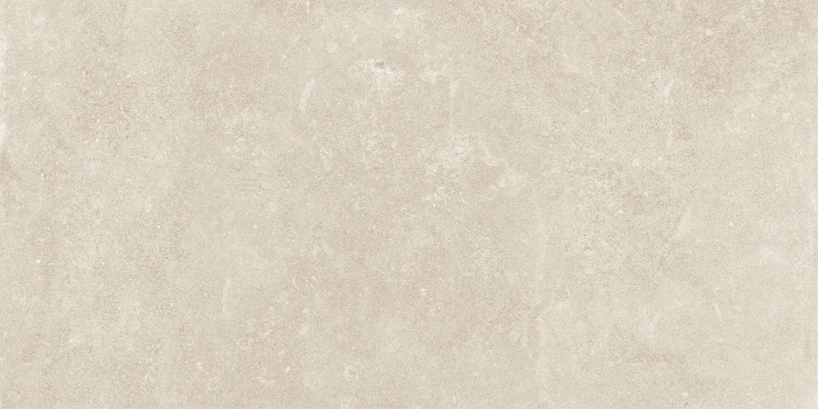 Revolve 12x24 Rectified Porcelain Tile offers a light beige, stone-like look with soft color variations and subtle speckling, creating a sophisticated, natural appearance and a non-slip floor finish.