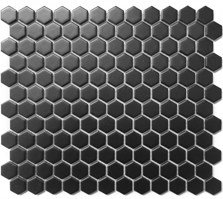 A sheet of Hexagon 1" Matte Mosaic Tile in small black hexagons, arranged in a honeycomb pattern and displayed on a white background.