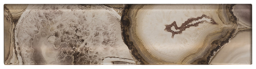 The Magical Forest 3x12 Glass Tile features a natural stone pattern with swirling shades of brown, beige, cream, and white, plus crystal-like details and concentric rings reminiscent of agate or geode.