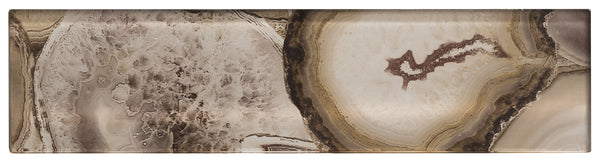 The Magical Forest 3x12 Glass Tile features a natural stone pattern with swirling shades of brown, beige, cream, and white, plus crystal-like details and concentric rings reminiscent of agate or geode.