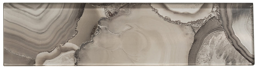 The Magical Forest 3x12 Glass Tile features swirling taupe, gray, and beige patterns resembling natural stone or agate, with layered textures—ideal for adding a dreamy, forest-inspired touch to any space.