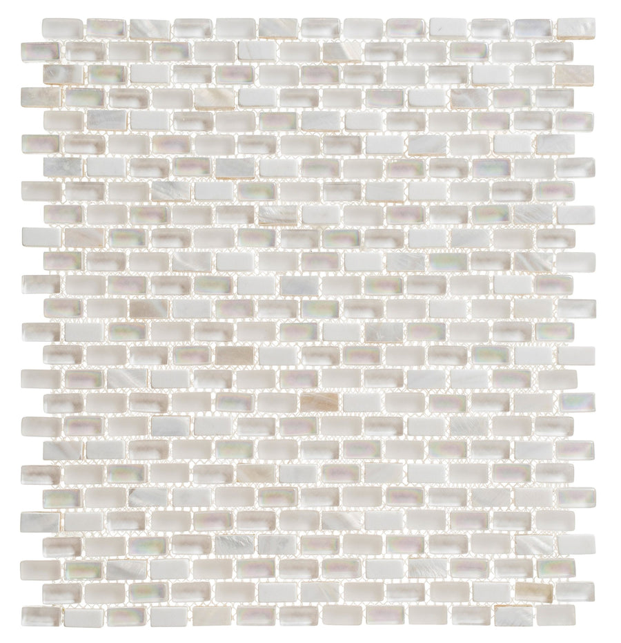 The Americana Glass Mosaic features small, glossy, iridescent white rectangular tiles in a horizontal brick pattern with thin beige grout lines, creating a neutral and elegant look.