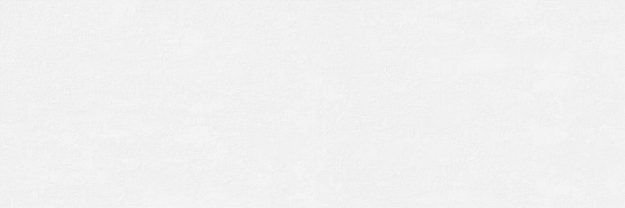 A plain white textured background mimics the look of an Omni 16x47 Rectified Glazed Ceramic Tile, featuring subtle variations and a lightly brushed or plastered effect across the surface.