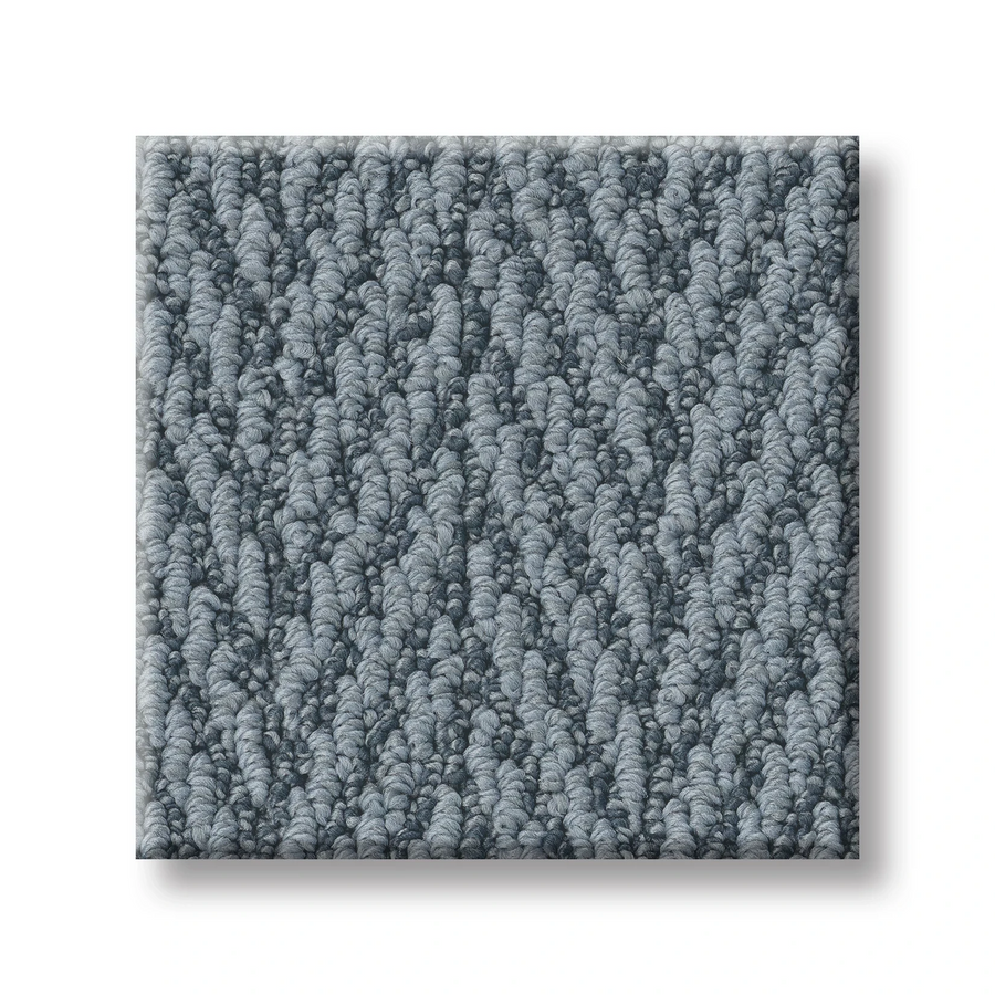 A square swatch of Always Natural On Trend Carpet in light gray, showcasing a textured herringbone pattern. Its dense, looped fibers offer premium softness and style—ideal for anyone seeking comfort and elegance in their flooring.