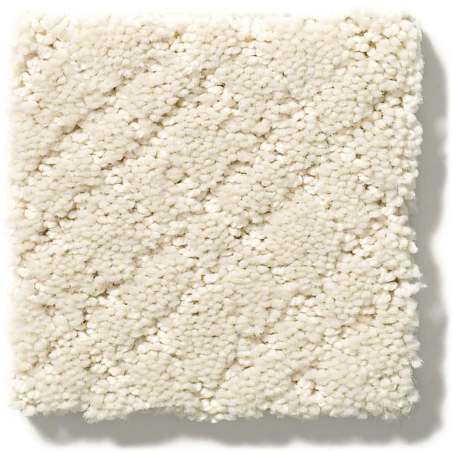 A square sample of Muse On Trend Carpet in textured off-white, featuring a subtle diagonal pattern. Plush fibers and soft neutral tones create an inviting look, displayed on a white background.