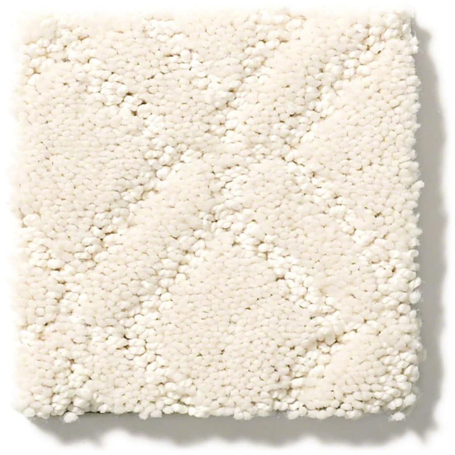 A close-up of Muse On Trend Carpet shows its white, textured surface with a subtle, slightly raised diamond pattern in soft neutral tones.