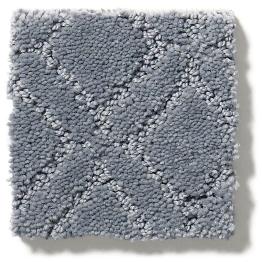 A square swatch of Muse On Trend Carpet in light gray features a raised, geometric diamond pattern in neutral tones. The plush, thick texture looks cozy, and right-side shadows highlight its three-dimensional surface.