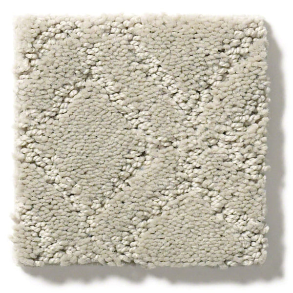 The Muse On Trend Carpet features a square swatch of light beige, textured plush fibers with a continuous geometric diamond pattern. Its neutral shades create a cozy, inviting look that suits any space.