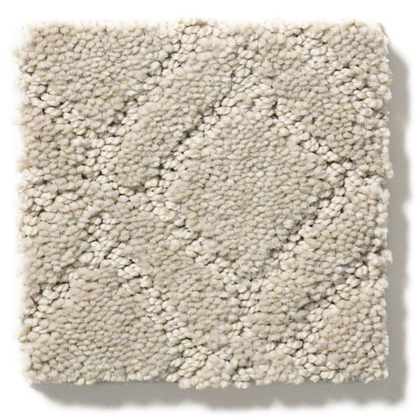 A close-up of Muse On Trend Carpet shows a square swatch in light beige with a subtle box grid texture. The neutral shades and plush, soft fibers give the carpet an inviting, stylish look.